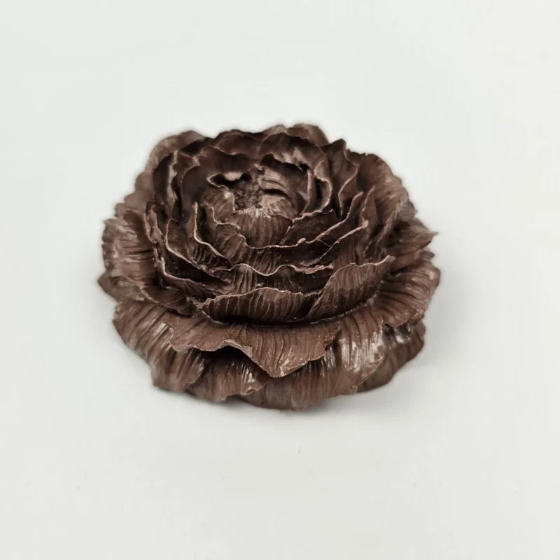 Ręcznie robiona dekoracyjna peonia z gipsu polimerowego w kolorze ciemnej czekolady, widok z boku ukazujący detale płatków.